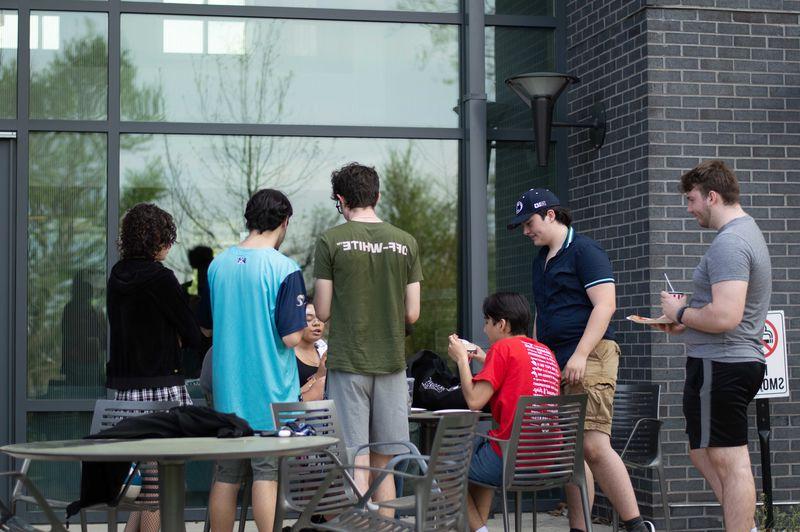 students sitting outside of Lions Gate