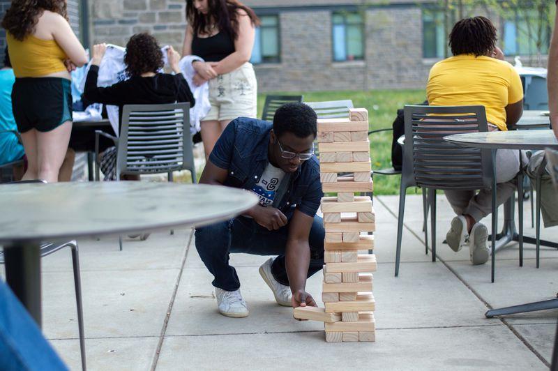 student playing Jenga outside